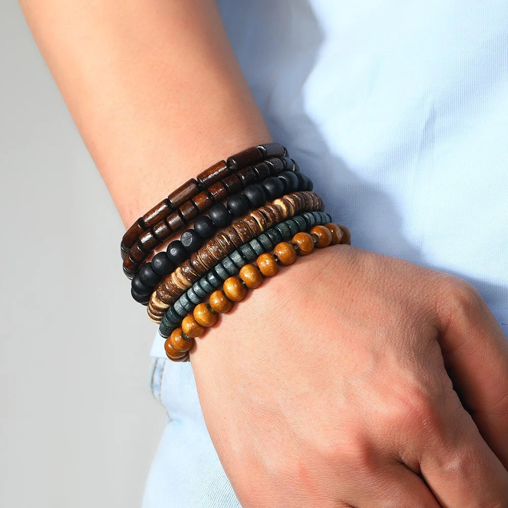 Stack of colorful beaded bracelets worn on a wrist.